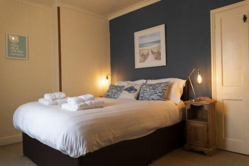 a bedroom with a bed with towels on it at Kittiwake Cottage, Seahouses in Seahouses