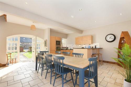 a kitchen and dining room with a table and chairs at Budle Granary in Bamburgh