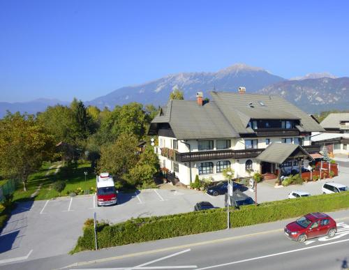 a bus parked in a parking lot next to a house at Guesthouse Leski Dvor in Lesce