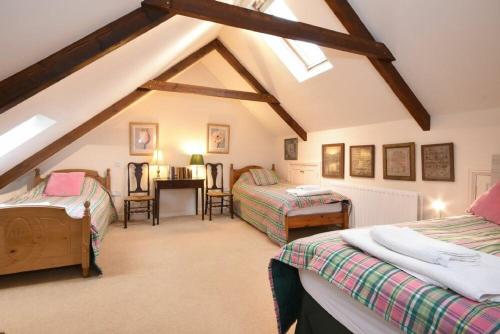 Habitación en el ático con 2 camas y escritorio en Craster Tower Coach House, en Craster