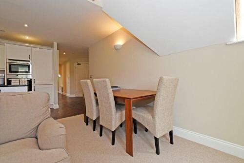 a dining room with a table and chairs at Sandpiper Bamburgh in Bamburgh