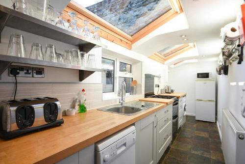 a kitchen with a sink and a counter top at Crier Cottage in Alnwick
