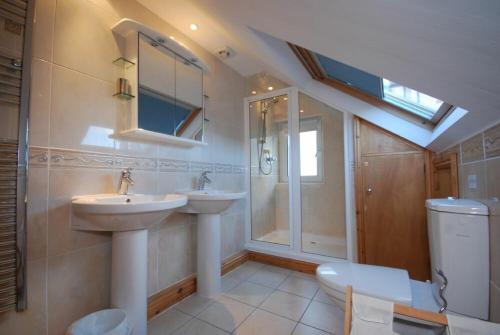 a bathroom with two sinks and a shower at Farne Lookout in Seahouses