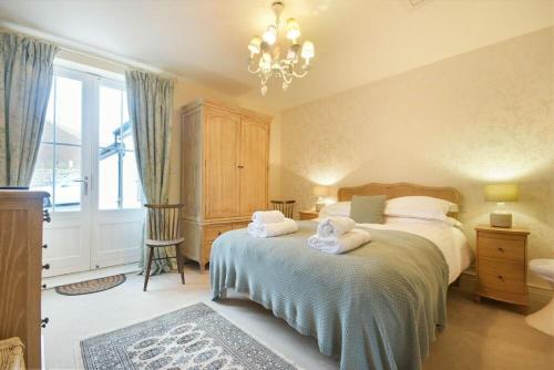 a bedroom with a bed with towels on it at Charlton Cottage in Bamburgh