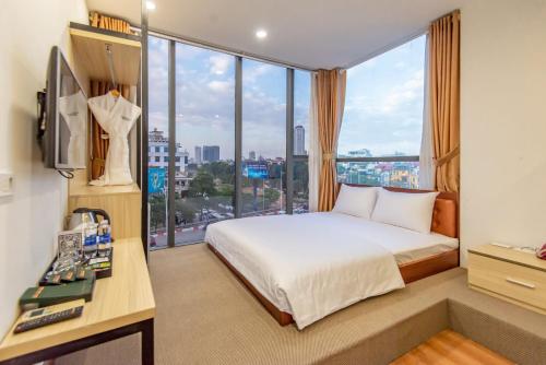 a hotel room with a bed and a large window at Coco Hotel Cau Giay in Hanoi