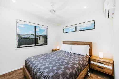 a bedroom with a bed and two windows at Mudgee Valley Park in Mudgee