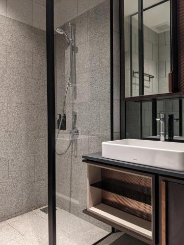 a bathroom with a sink and a shower at Scarletz Suites KLCC by Mana-Mana in Kuala Lumpur
