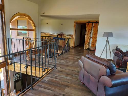 a living room with a couch and a staircase at Morrena Lodge in Torres del Paine