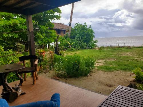 a view of the ocean from the porch of a house at Patrick's on the Beach Resort in General Luna