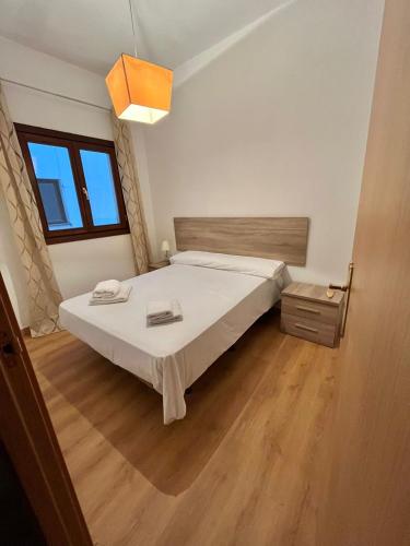 a bedroom with a bed and a wooden floor at María Cristina 2 in Córdoba