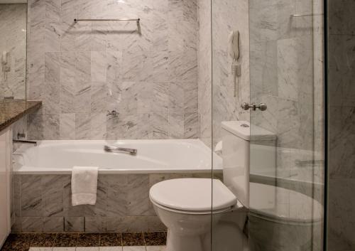 uma casa de banho com uma banheira, um WC e um chuveiro em Quay West 1301 Self- Catering em Sydney