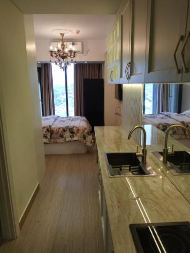 a kitchen with a sink and a counter top at Alexa Meisterstadt pollux habibie in Batam Center
