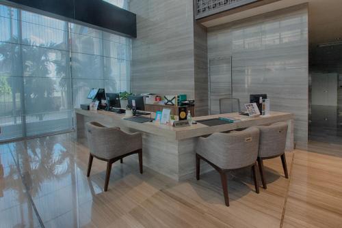 an office with a counter with chairs and a desk at GRANFERTE Phnom Penh Hotel in Phnom Penh