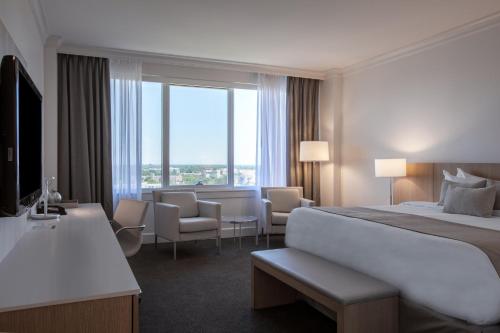 a hotel room with a bed and a large window at InterContinental Cleveland, an IHG Hotel in Cleveland