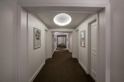 an empty hallway with a light fixture on the ceiling at InterContinental Cleveland by IHG in Cleveland
