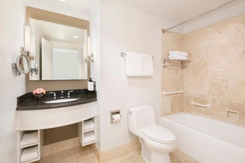 a bathroom with a sink and a toilet and a tub at InterContinental Cleveland by IHG in Cleveland