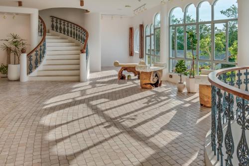 a staircase in a house with shadows on the floor at Ampersand Resort in Bophut 
