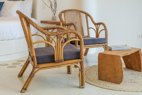 a room with two chairs and a table and a bed at Ampersand Resort in Bophut 