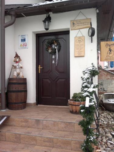 a front door of a house with a wreath on it at Restaurace a penzion U Hasičů in Klimkovice