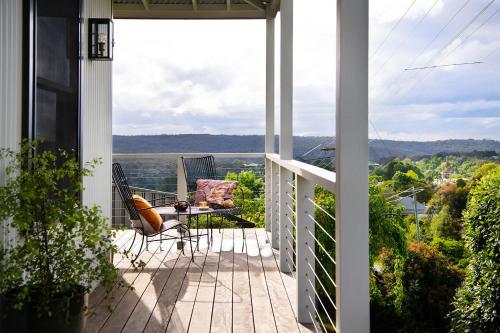 a porch with a table and chairs on a balcony at Stockton House- spectacular 2 bedroom home in Daylesford