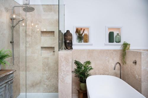 a bathroom with a shower with a toilet and a tub at Stockton House- spectacular 2 bedroom home in Daylesford