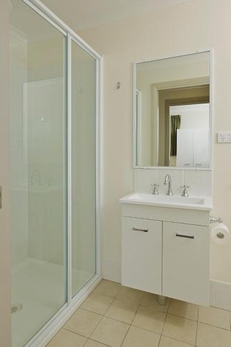a bathroom with a shower and a sink and a mirror at Mudgee Valley Park in Mudgee