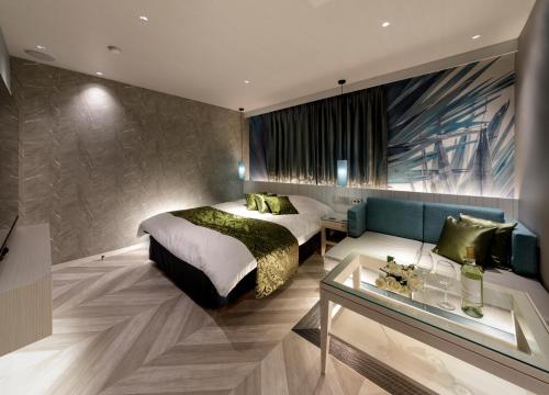 a bedroom with a bed and a glass table at Hotel Cocoon -Urban Luxury- in Suka