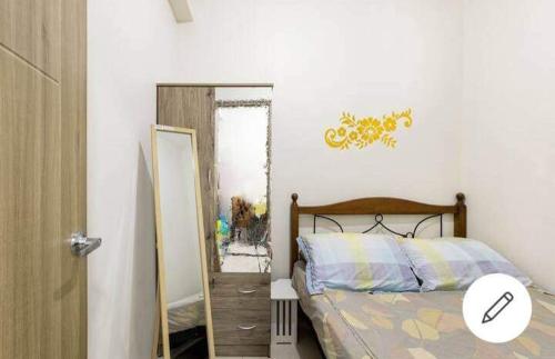 a bedroom with a bed next to a mirror at Paranaque SM-Sucat Field Res. Bldg 5, 2/F, 2BR with Balcony in Manila