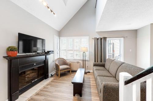 a living room with a couch and a fireplace at Condo 916 at North Creek Resort in Blue Mountains