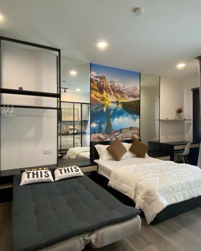 a bedroom with two beds and a painting on the wall at Vista Bangi Soho UKM, Swimming pool & River view in Kajang