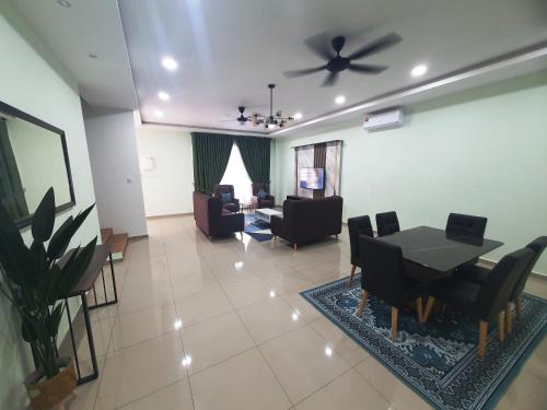 a living room with a ceiling fan and a table and chairs at RR Homestay in Kluang