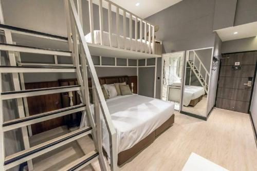 a bedroom with two bunk beds and a staircase at Narawad Boutique Hotel in Bangkok