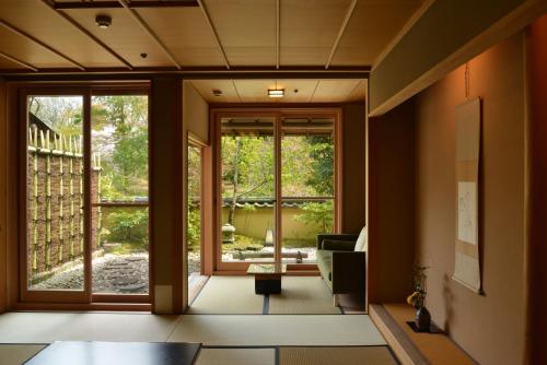 a living room with a large sliding glass door at Gora Kadan in Hakone