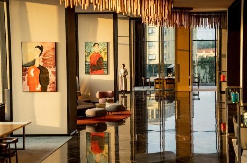 a living room with a lobby with paintings on the walls at Crowne Plaza Vinh Yen City Centre, an IHG Hotel in Yen