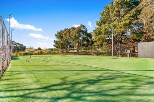 a tennis court with two tennis courts at Montfort Manor in Traralgon