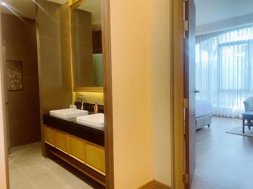 a bathroom with a sink and a mirror at Grand Lord Hotel & Residence - Khao chi chan Pattaya in Na Jomtien