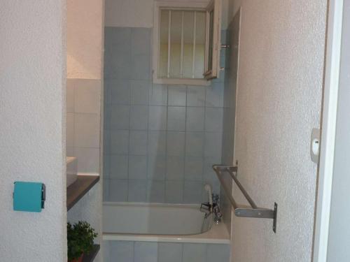 een badkamer met een bad en een wastafel bij Appartement Marseillan-Plage, 2 pièces, 4 personnes - FR-1-387-50 in Marseillan