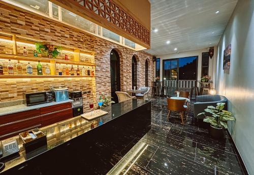 a bar in a restaurant with a brick wall at Grand Lord Hotel & Residence - Khao chi chan Pattaya in Na Jomtien