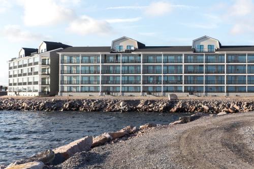 a large building on the beach next to the water at Suite Portus - Design apartment by the sea in Hanko