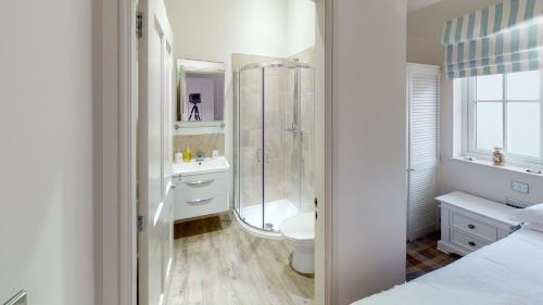 a bathroom with a shower and a toilet and a sink at Blue Anchor Retreat at The Bay Filey, sleeps 4, 2 dogs welcome for free too in Filey