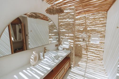 a bathroom with two sinks and a mirror at Belajar Bali Boutique Hotel and Retreat in Canggu