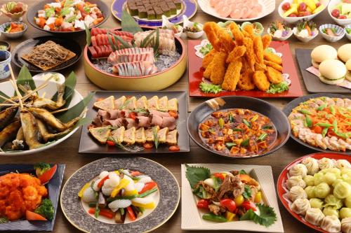 a table full of different types of food on plates at Sky Park Hotel in Chino