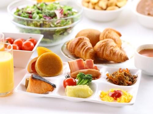 a plate of breakfast foods on a table at Sky Park Hotel in Chino