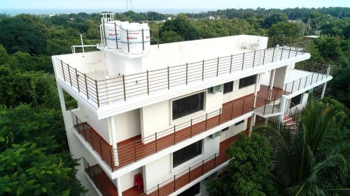 an overhead view of a building with trees in the background at The Canopy Guest House in Auroville