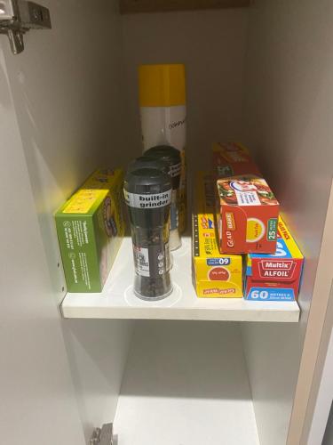 a shelf in a refrigerator with a cup of coffee and cereal at Morros Place in Hay