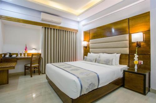 a bedroom with a bed and a desk in a room at Hotel Afford Inn in Dhaka