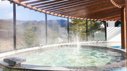 a swimming pool with a fountain in a house at Phoenix Hotel Pyeongchang in Pyeongchang