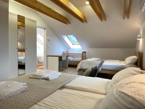 a bedroom with two beds and a balcony at Apartment ANMARI in Radovljica
