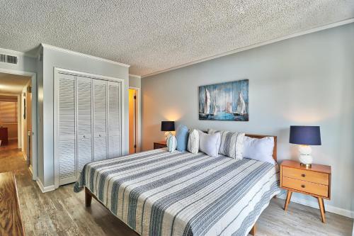 a bedroom with a bed with a striped bedspread and a nightstand at Beach &nightlife 3BR/2.5 BA service dog friendly in Myrtle Beach
