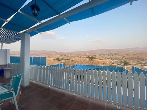 a view from the balcony of a house with a white fence at Aqua Blue Villa-Dead Sea, Jordan in Amman